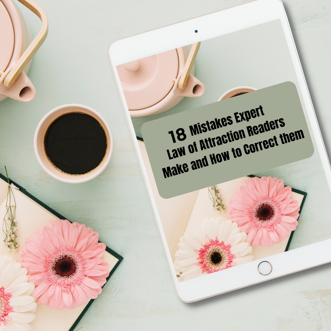 Tablet displaying a book cover with pink flowers and text on a light green surface with a cup of coffee. The ebook title is " 16 mistakes expert law of attraction readers make and how to correct them"