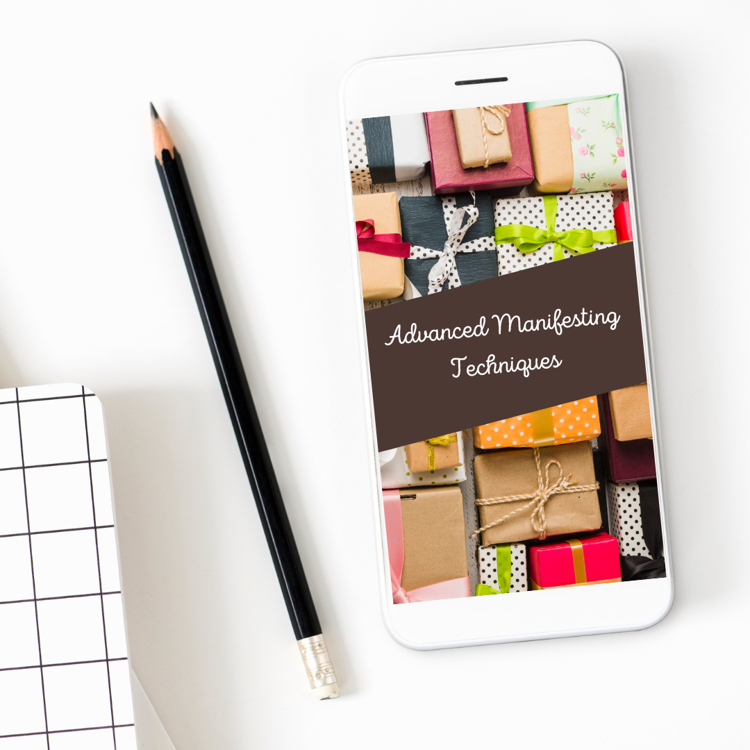 Phone displaying 'Advanced Manifesting Techniques' with colorful gift boxes on a white surface that features the digital guide titled " Advanced Manifesting Techniques "
