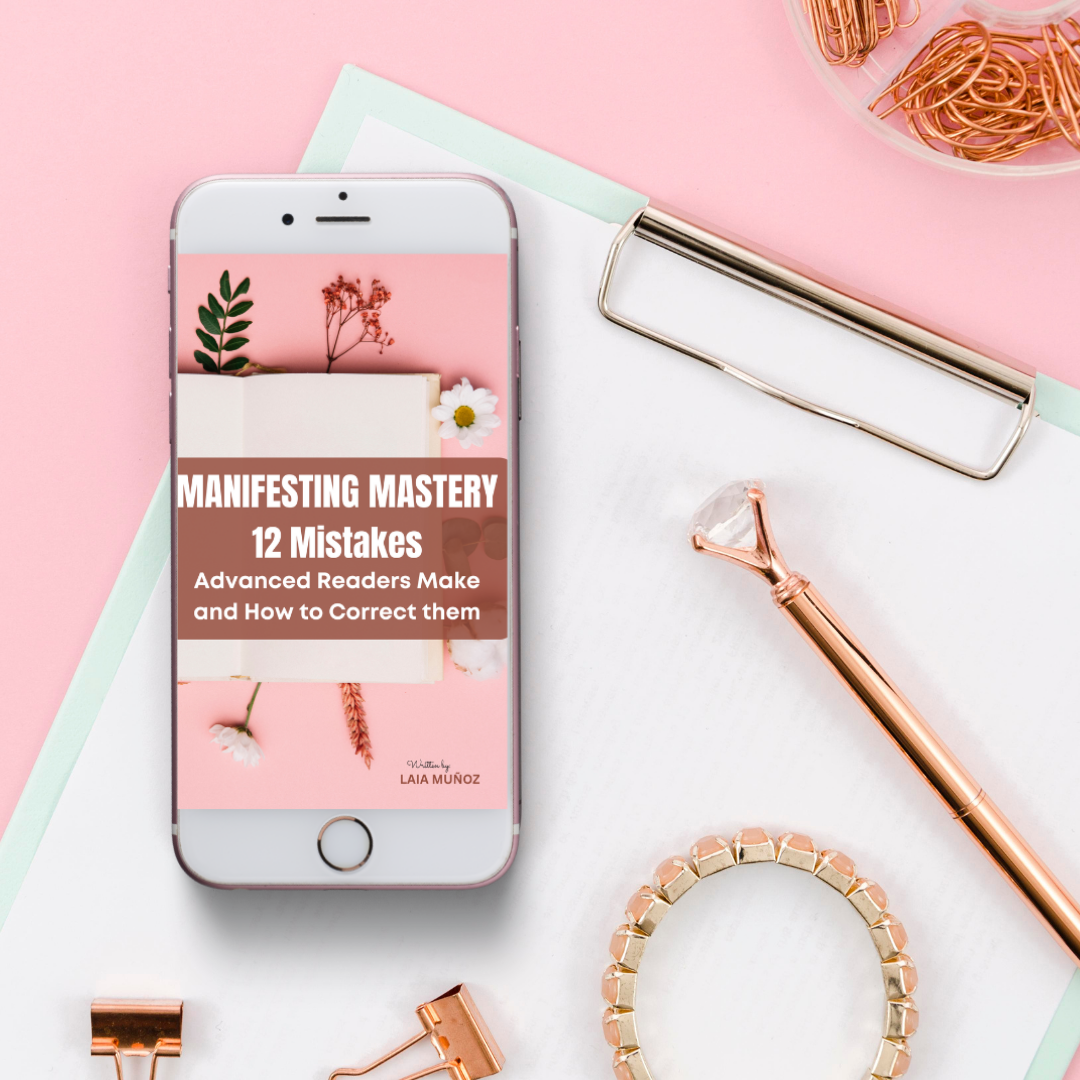 a phone and a gold rsose pen featuring an ebook called  " Mistakes advanced law of attraction make "