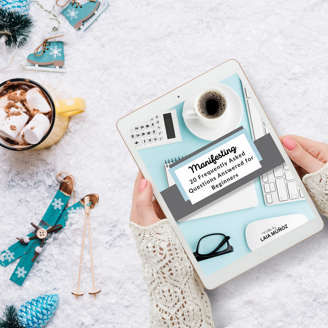 a tablet and littile skiis featuring the ebook " manifesting 20 FAQS for beginners "