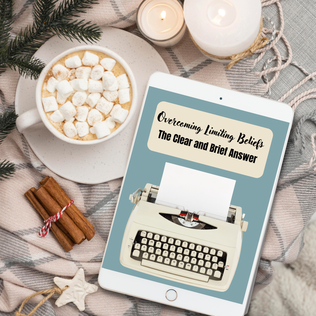 Tablet displaying a book cover with a typewriter illustration, surrounded by a cup of hot chocolate with marshmallows, candles, and cinnamon sticks on a textured surface, featuring an ebook called " Overcoming limiting beliefs "